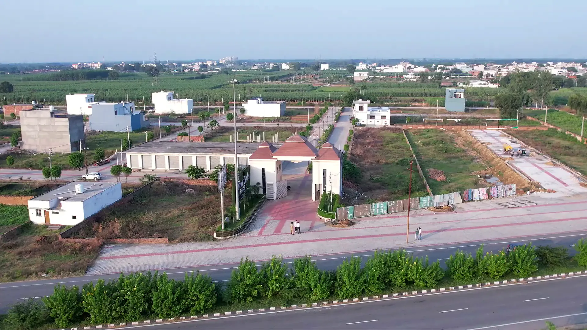 Aerial view of the Defence Garden Phase 2 entrance on the main road, with the shopping block and plotted streets behind it
