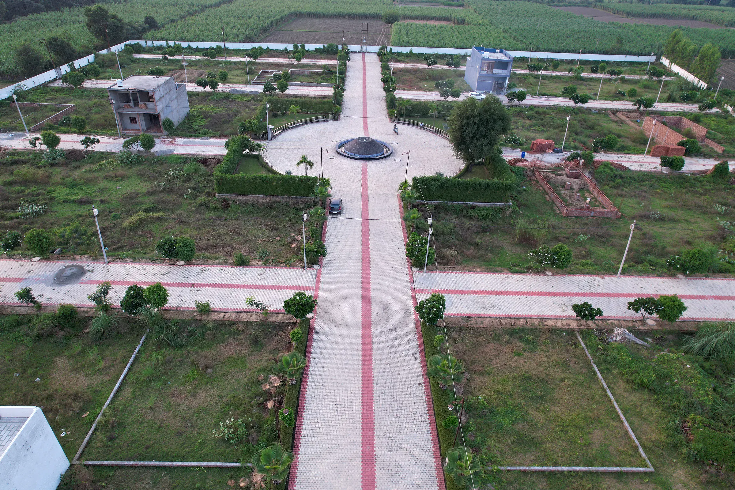 River Green Society: the red-striped central boulevard leading to the fountain roundabout, with plots and young trees on either side