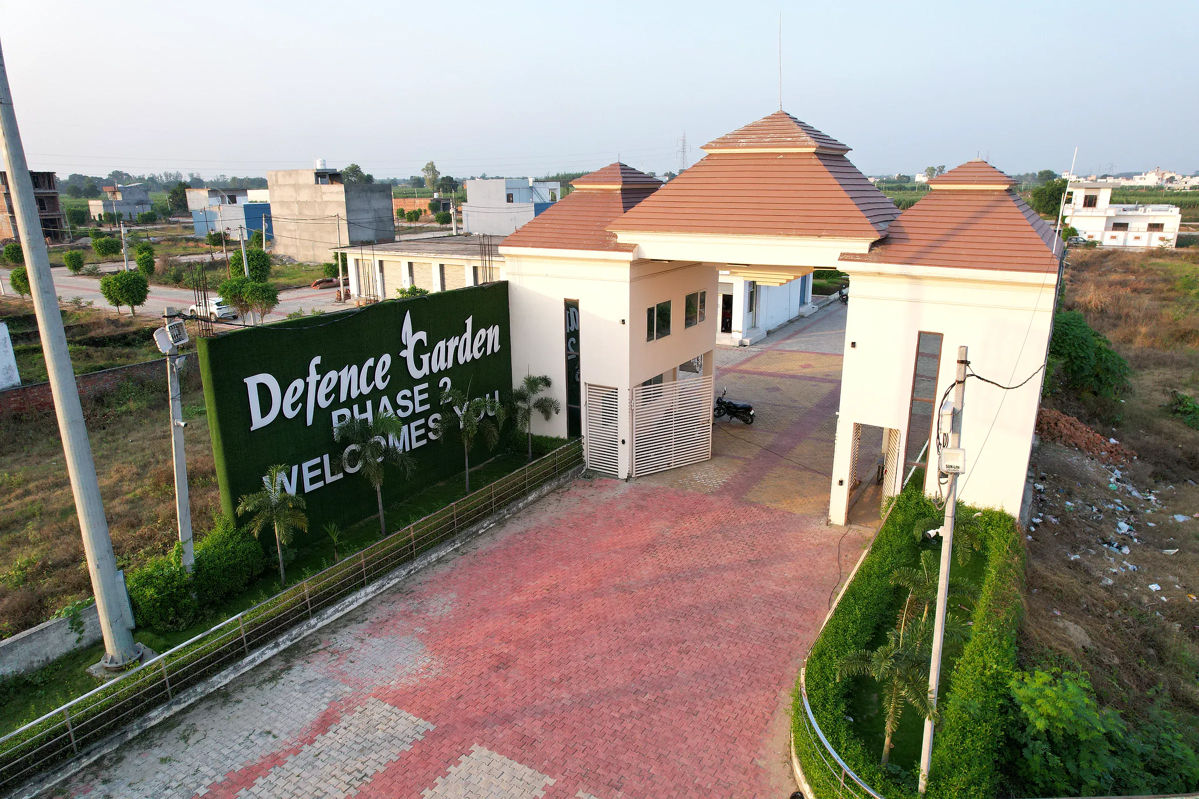 The red-roofed gatehouse of Defence Garden Phase 2 and its paved forecourt