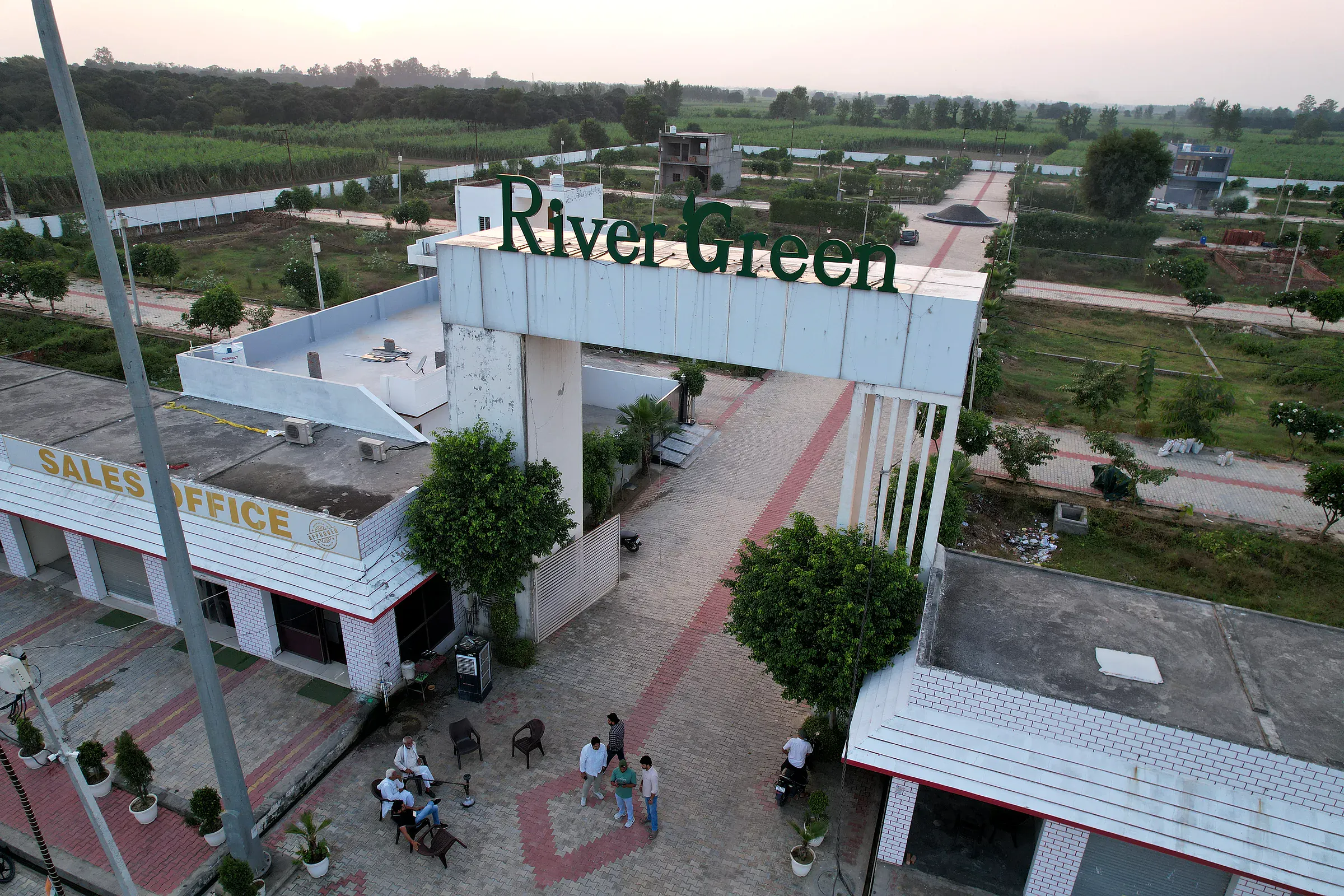 Visitors at the River Green Society sales office beneath the entrance arch