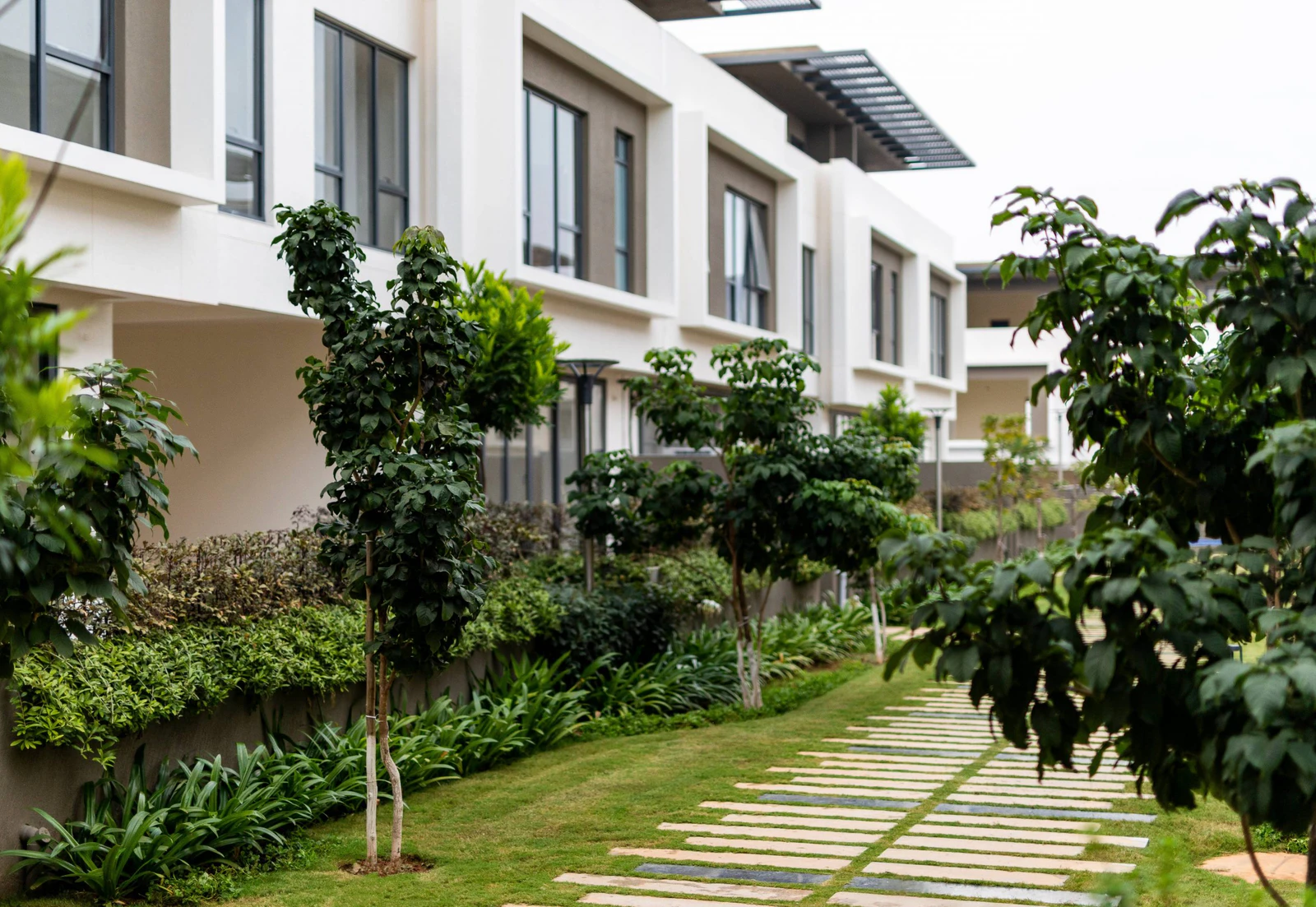 Landscaped pedestrian lane between independent two-storey villas at Alanoville in Bengaluru