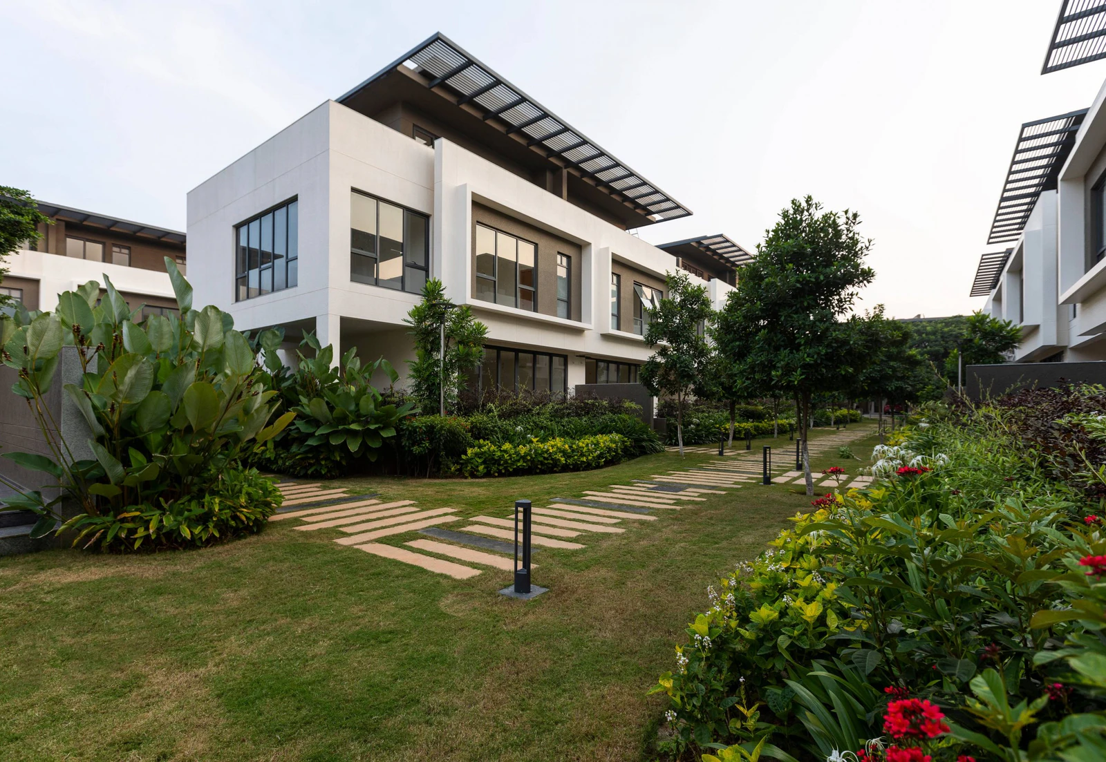 Garden walkways and private terraces between rows of independent villas at Alanoville in Bengaluru