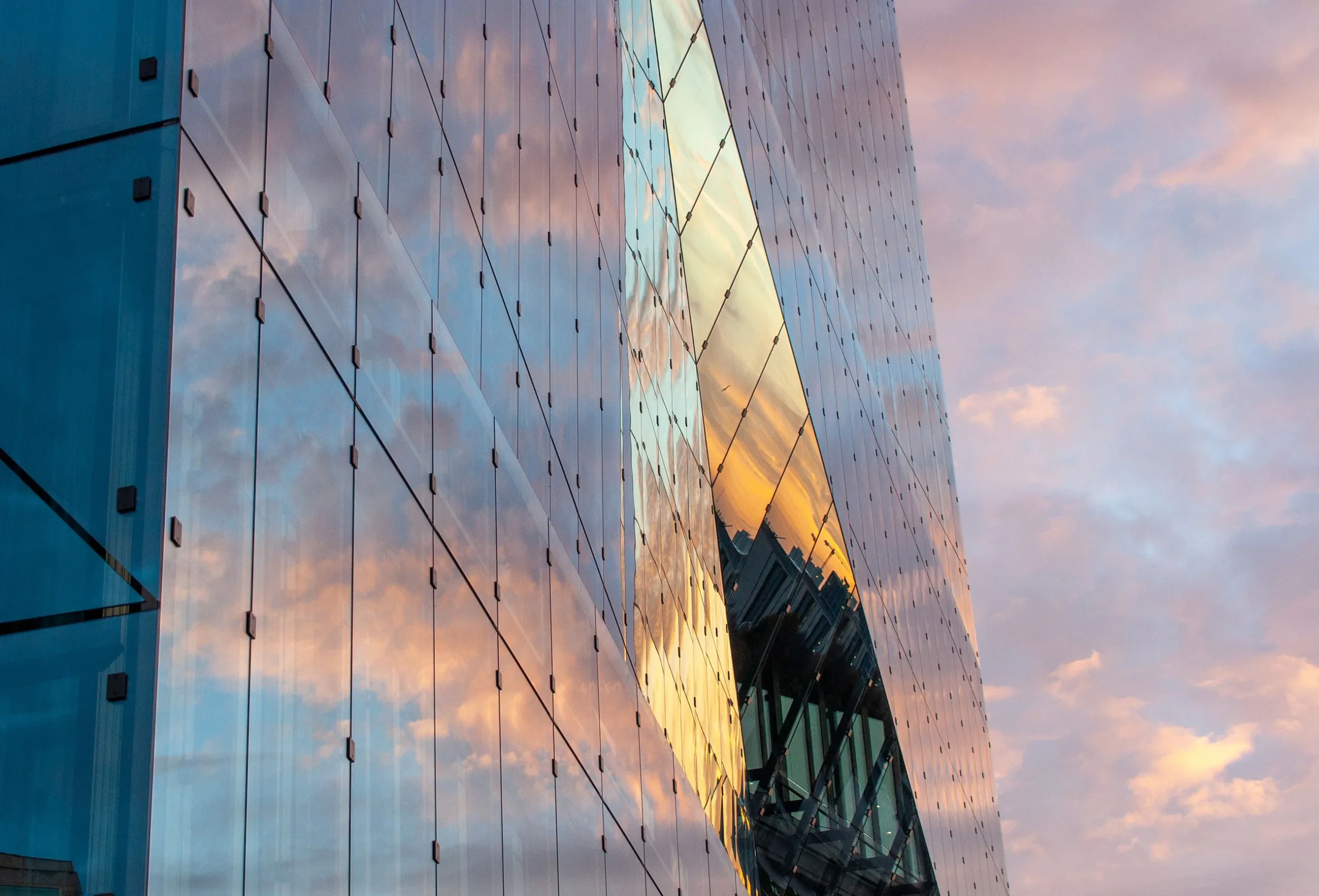 Glass building reflecting the evening sky