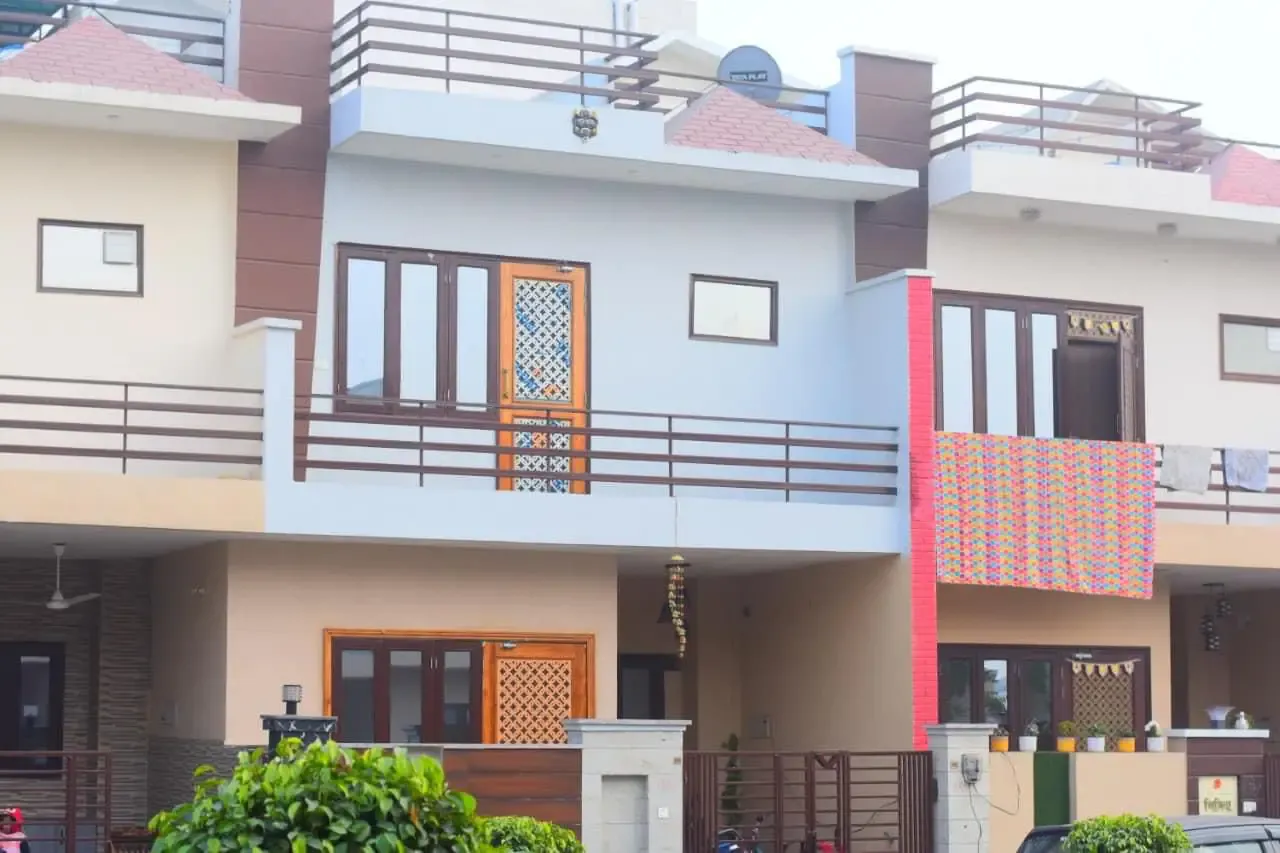 Ganpati Enclave: townhouse facades with balconies and timber screens