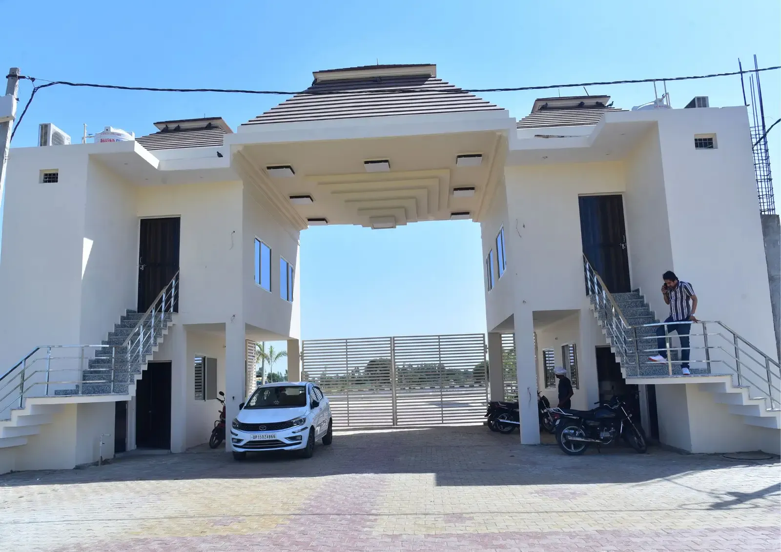 Defence Garden Phase 2 gatehouse seen from inside, with guard rooms, staircases and a parked car