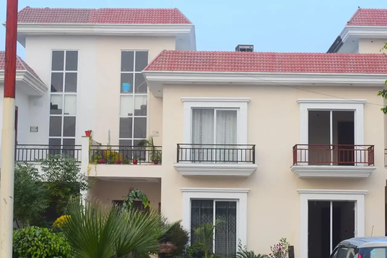 Ganpati Enclave: cream villas with red-tiled roofs and wrought-iron balconies