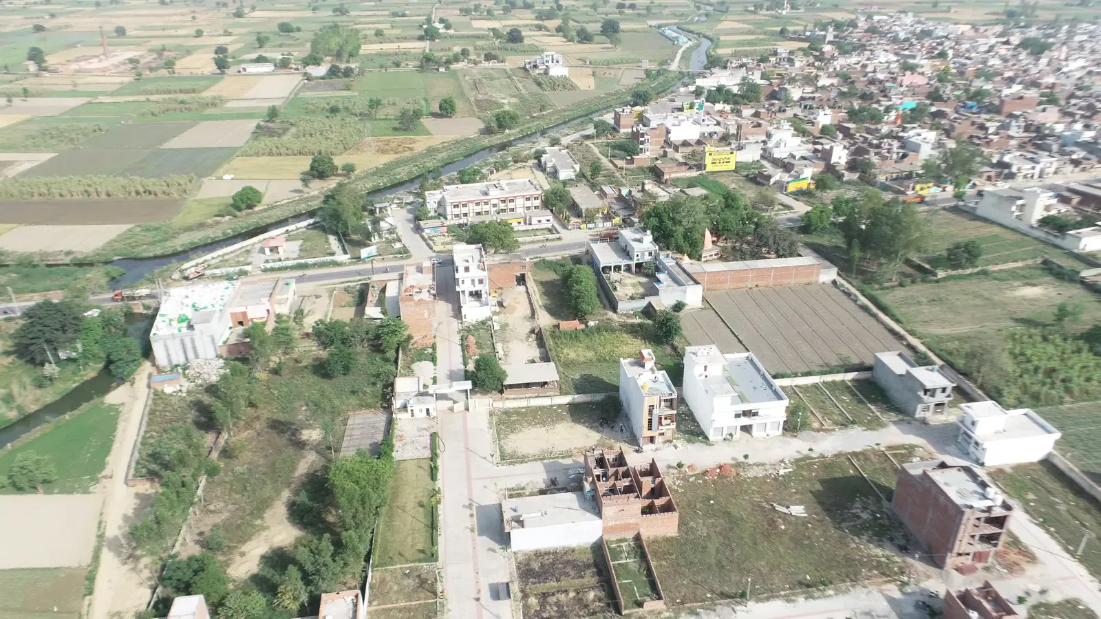 Aerial view of the Defence Garden Phase 1 colony with a canal and the town beyond