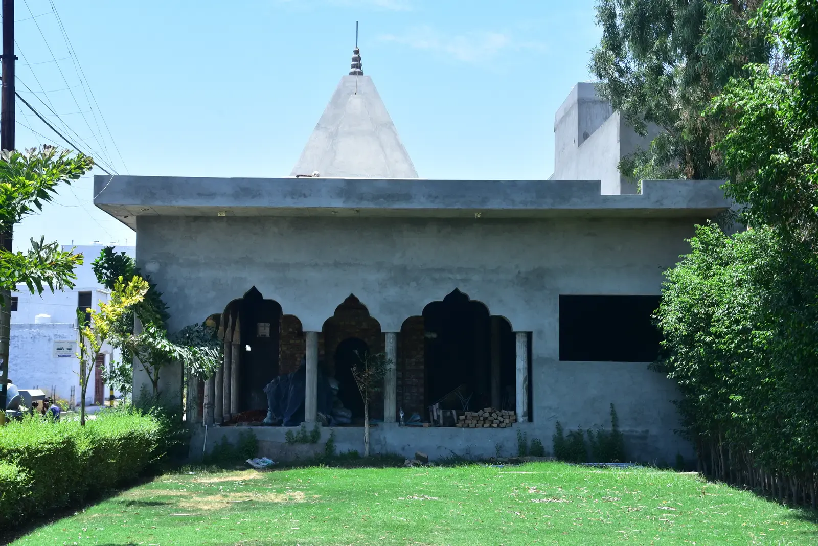 Defence Garden Phase 1: temple building with arched openings and a spire beside a green lawn