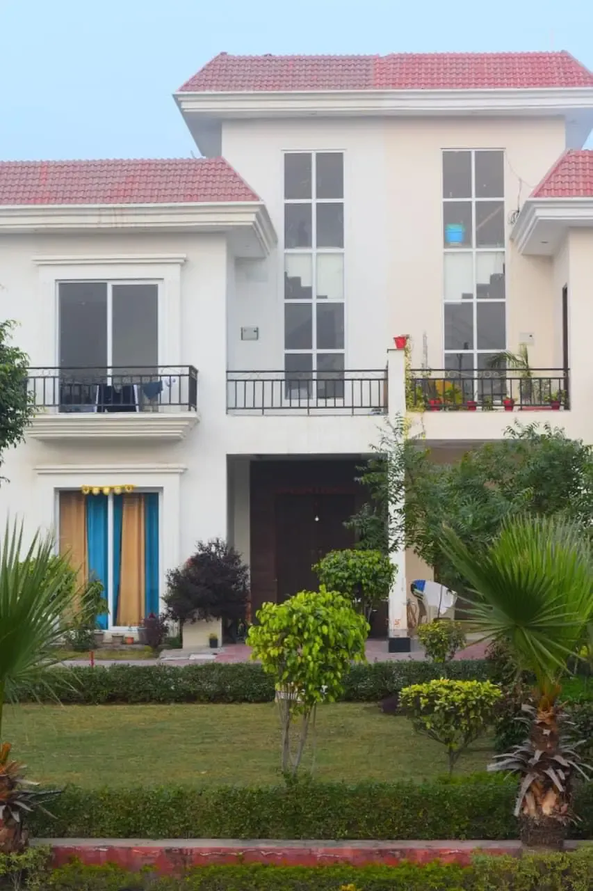 Ganpati Enclave: cream villa with a front lawn