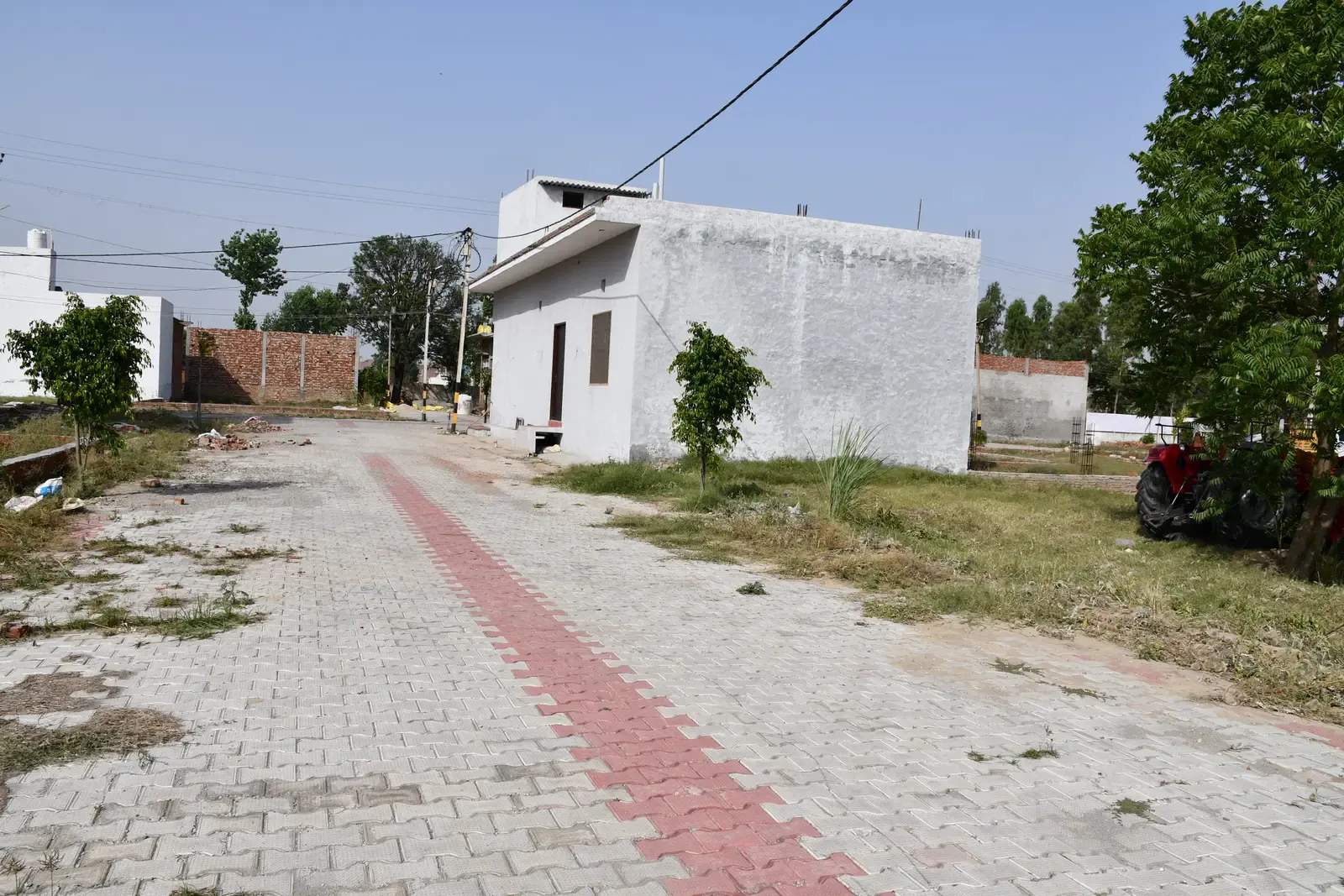 Defence Garden Phase 1: paved internal road with a red centre stripe beside a new single-storey house