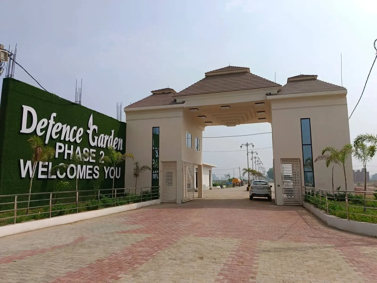 Defence Garden Phase 2 entrance gate and green welcome wall on an overcast day