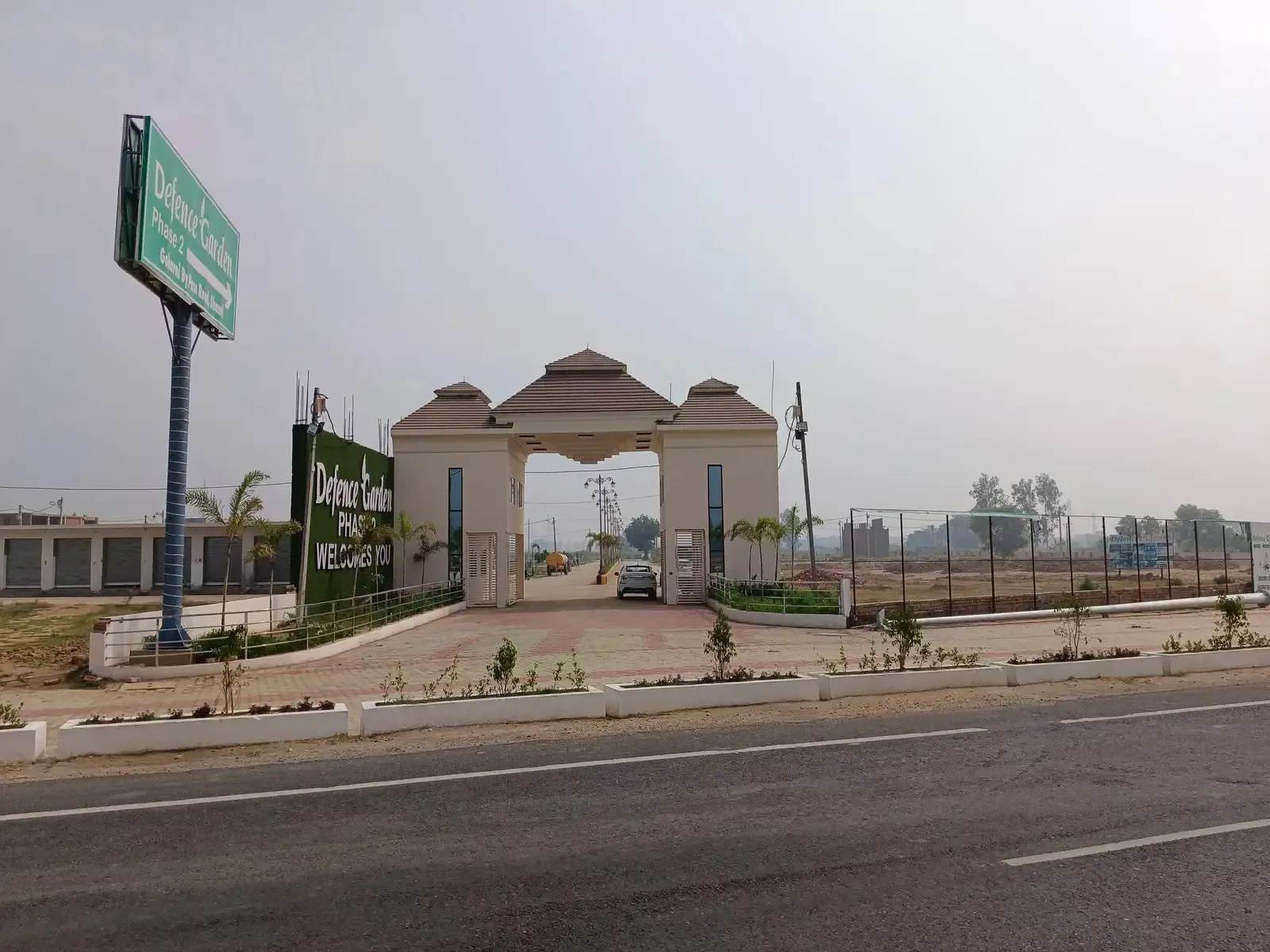 Defence Garden Phase 2 entrance seen from across the main road, with its tall roadside sign