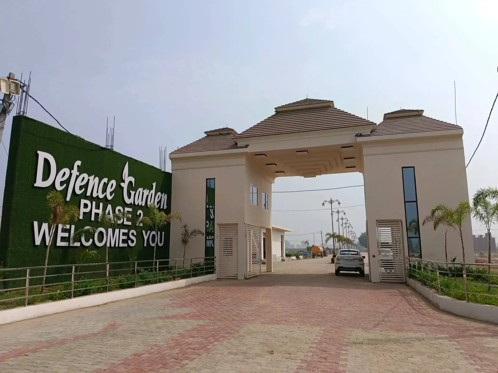 Defence Garden Phase 2 entrance gate beside the green "Welcomes You" wall