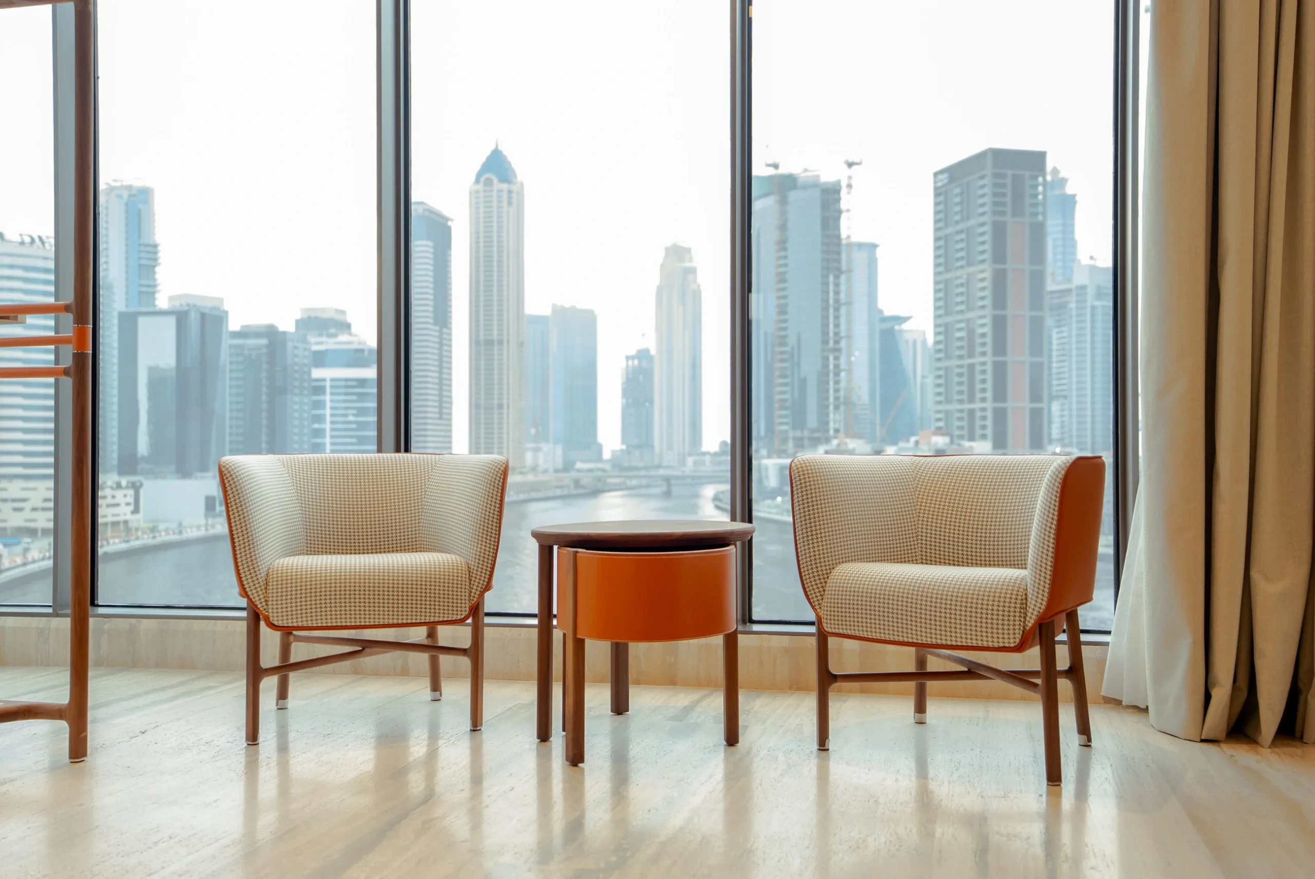 Residential interior with full-height windows and a view of the city