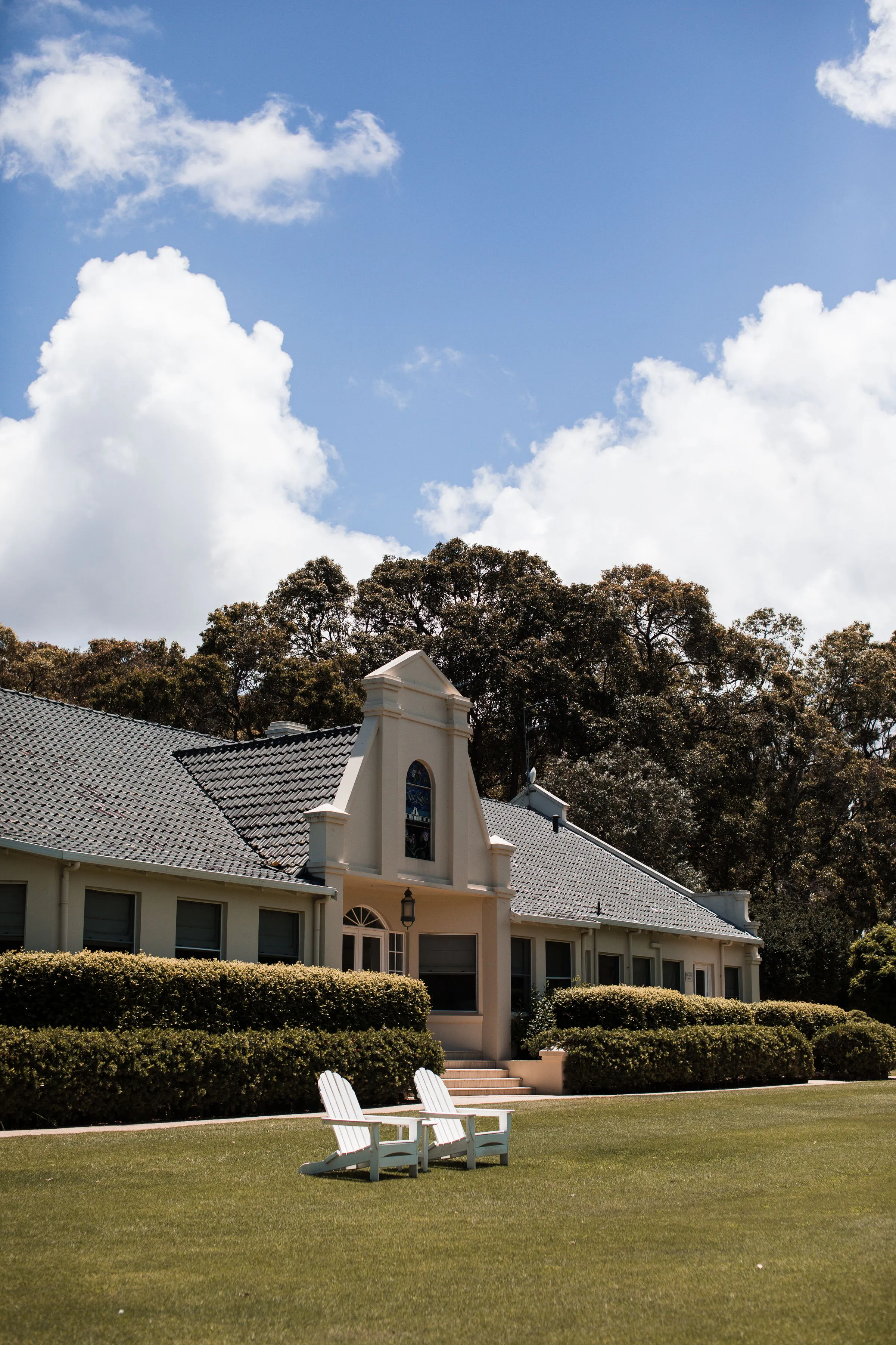 Country residence with a broad lawn and outdoor lounge chairs