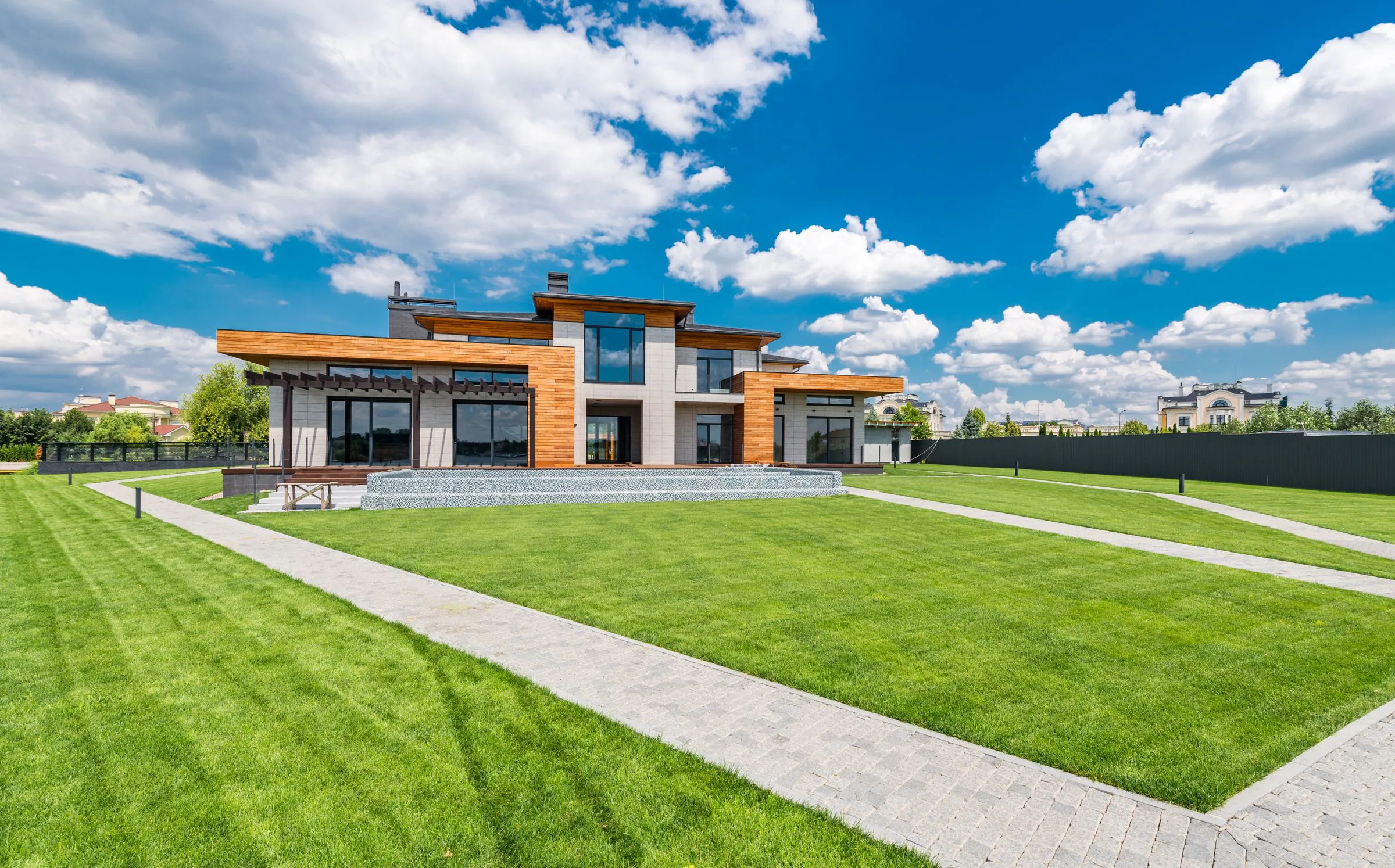 Low contemporary villa with a striped lawn and paved garden paths