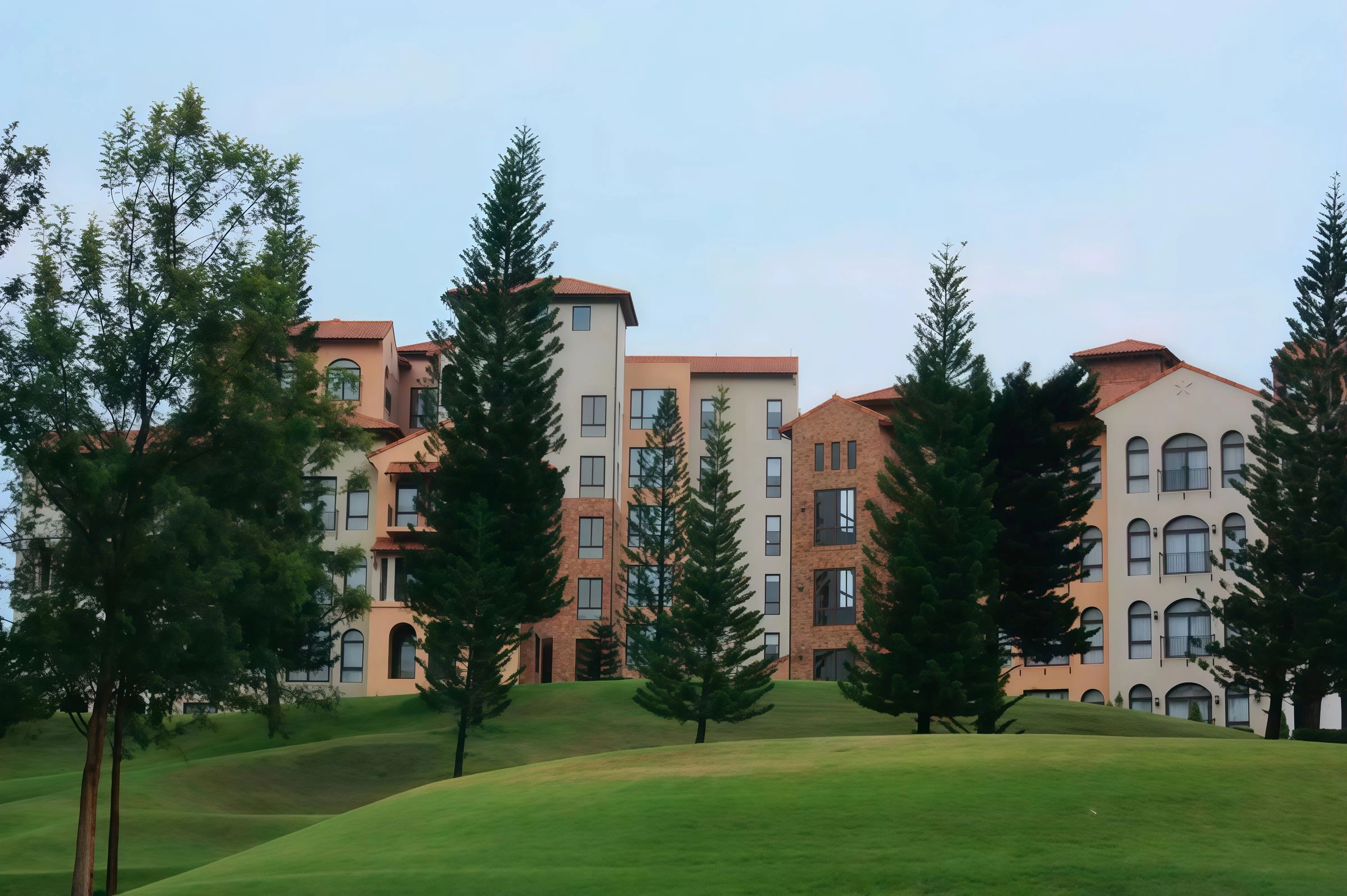 Residential buildings surrounded by maintained lawns and trees