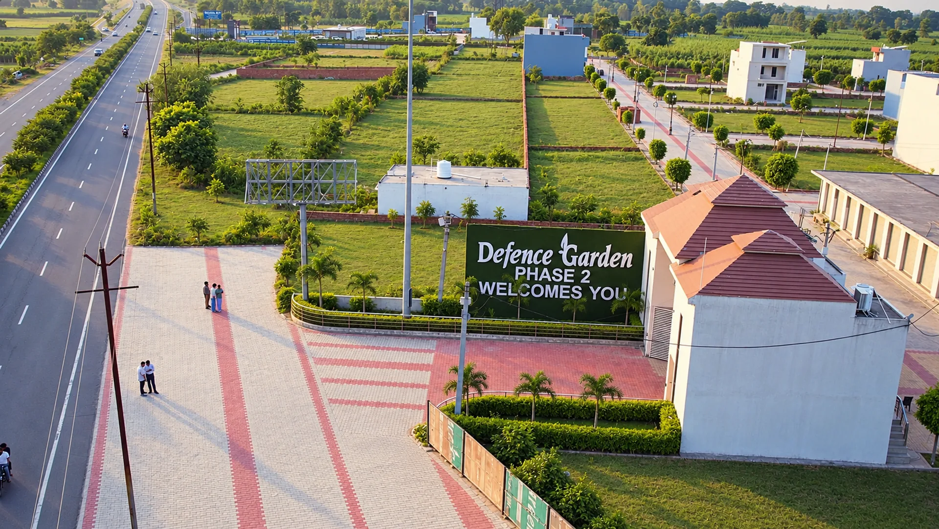 The pavilion entrance and Defence Garden Phase 2 welcome sign beside the highway